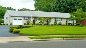 Manicured front lawn and garden bed outside a suburban house