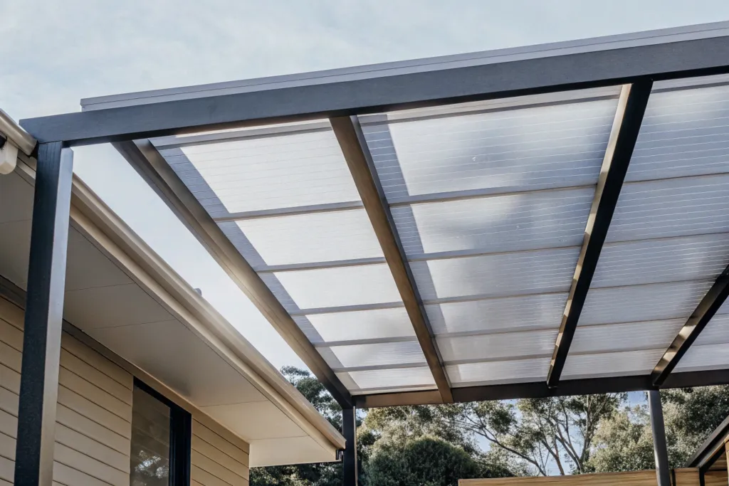 Close-up of a pergola frame with a polycarbonate roof panel